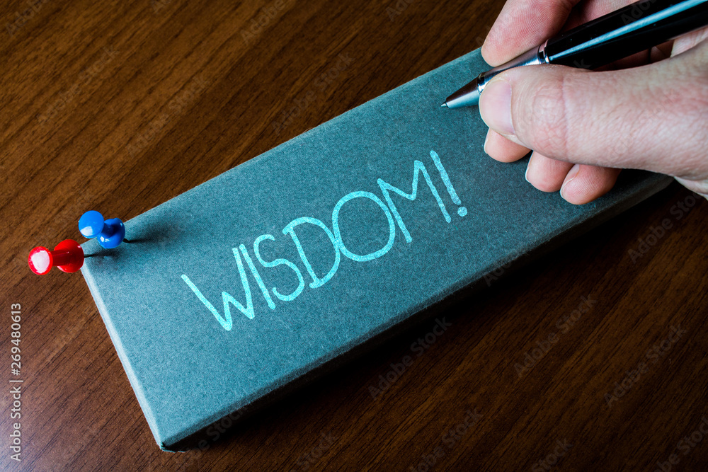 Writing note showing Wisdom. Business concept for quality having experience knowledge and good judgement something Close up left man right hand holding pen fixed pins lying wooden table Writing note showing Wisdom. Business concept for quality having experience knowledge and good judgement something Close up left man right hand holding pen fixed pins lying wooden table