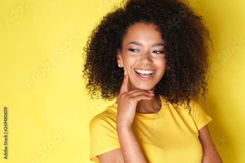 Fotografia, Obraz Close up of a happy afro model laughing and looking at the side.