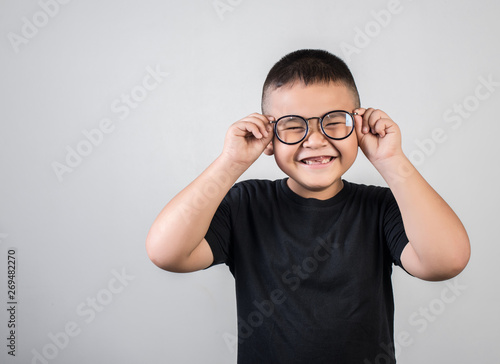 Funny boy genius wearing glasses in studio shot