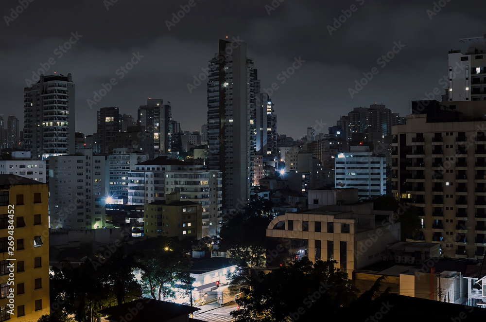 Buildings of Sao Paulo city at a cloudy night. Urban photo of the city during night. Buildings of Sao Paulo city at a cloudy night. Urban photo of the city during night.