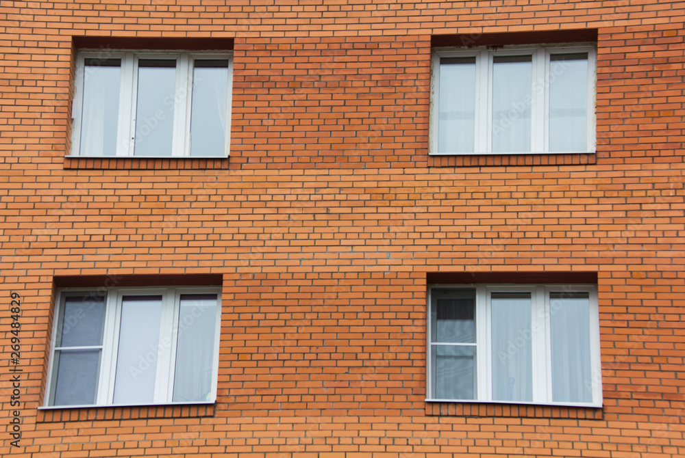 window background of a high multi-storey residential building. Many windows.