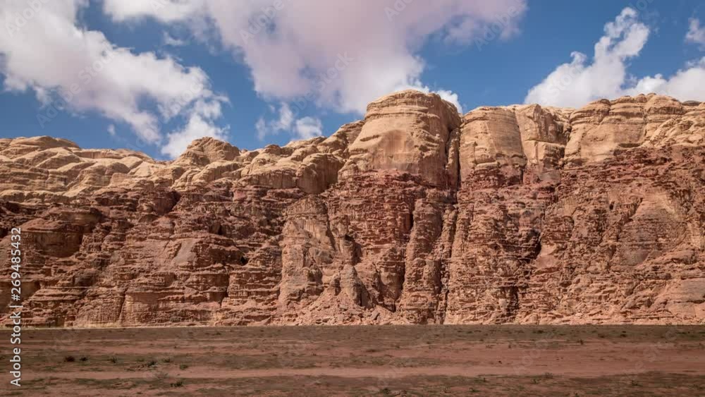 Stone desert landscape. White clouds move fast over the red rocks. Time lapse video Stone desert landscape. White clouds move fast over the red rocks. Time lapse video