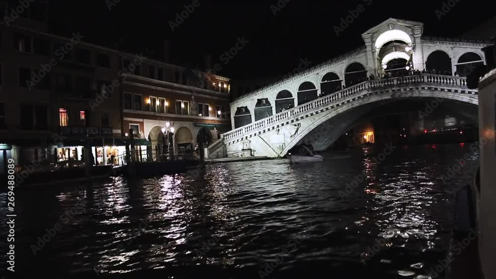 Night lighting on the Grand Canal, Venice. Beautiful view at night on the Rialto Bridge, Italy. Reflections on the water. Tourists on the bridge. Amazing landscape. Night lighting on the Grand Canal, Venice. Beautiful view at night on the Rialto Bridge, Italy. Reflections on the water. Tourists on the bridge. Amazing landscape.