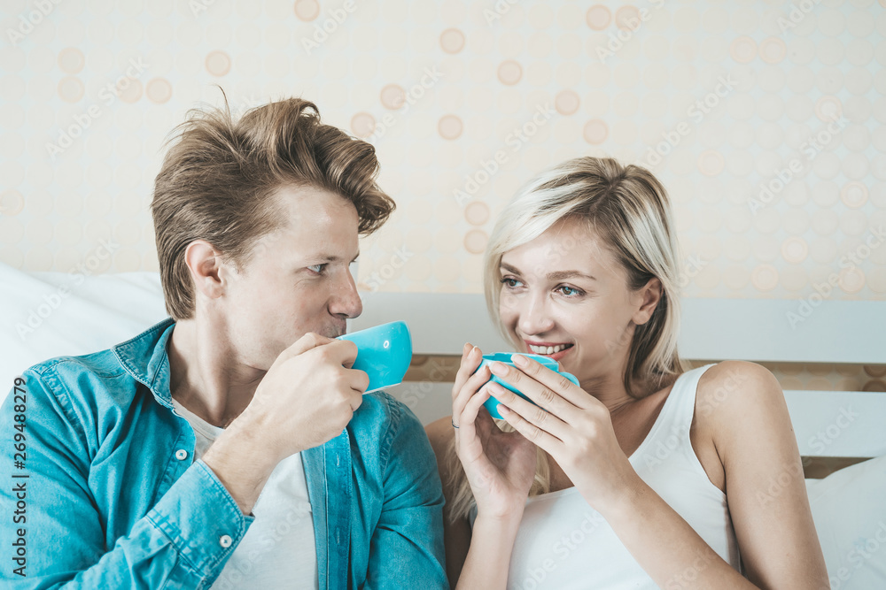 Happy couple hand holding cup and drinking coffee in the morning Happy couple hand holding cup and drinking coffee in the morning