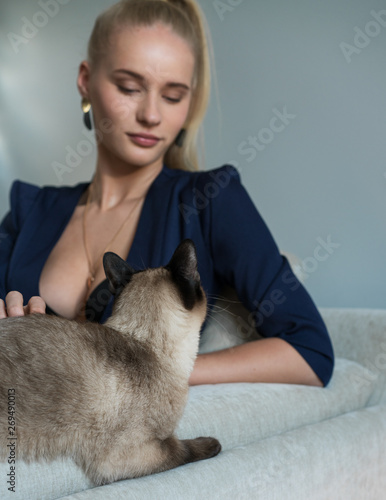 blond girl in bra and dark blue jacket. Fashion woman in ligth room.
