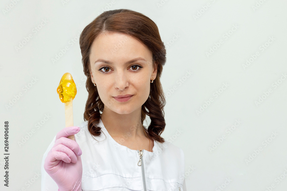 sugar depilation cosmetic procedure shugaring beautiful girl master holds sugar paste in his hands concept sugar depilation cosmetic procedure shugaring beautiful girl master holds sugar paste in his hands concept