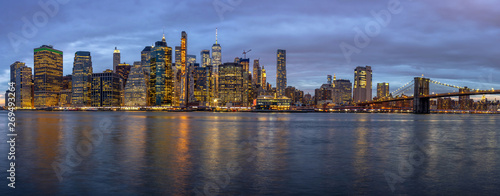 Panorama scene of New york Cityscape with Brooklyn Bridge beside the east river at the twilight time, USA downtown skyline, Architecture and building with tourist concept