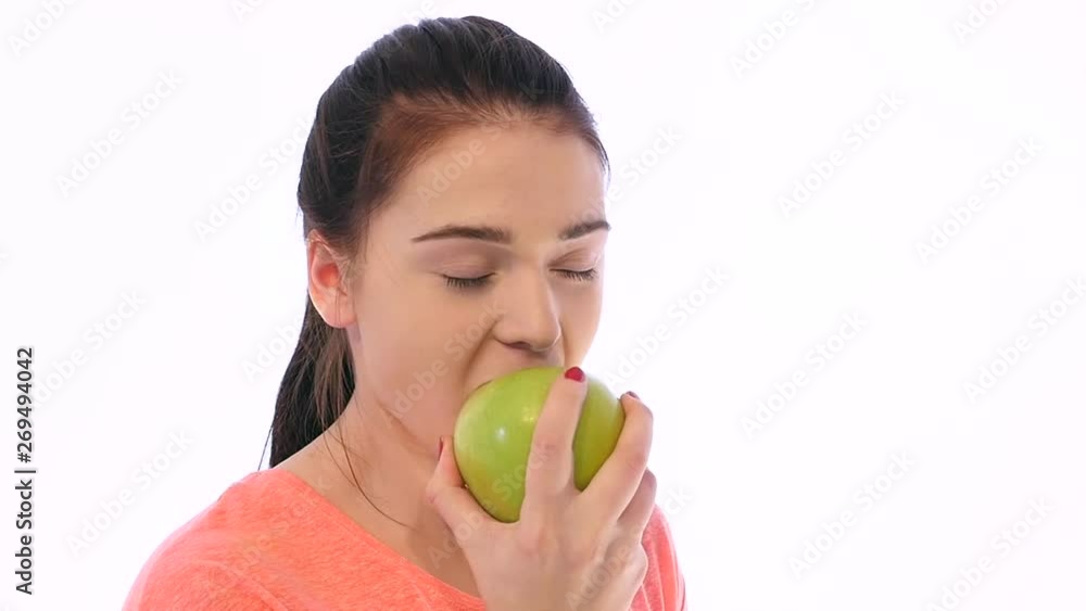 Healthy Joyful Young Woman Eating Green Apple and Smiling. Healthy Joyful Young Woman Eating Green Apple and Smiling.
