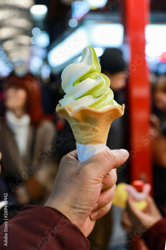 Green tea flavored ice cream on young girl hand,japanese street food