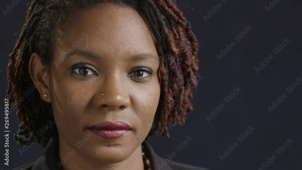 Young black woman looking at camera and looking away Young black woman looking at camera and looking away