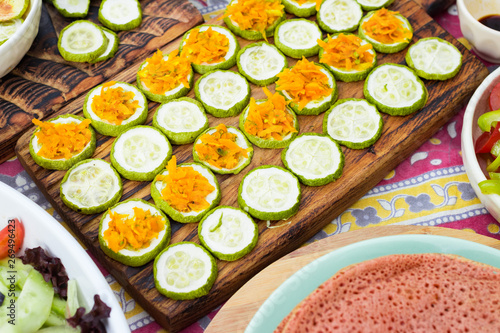 Baked roasted zucchini circles on board with carrot stuffing. Vegan lunch, vegetarian dinner, healthy food.