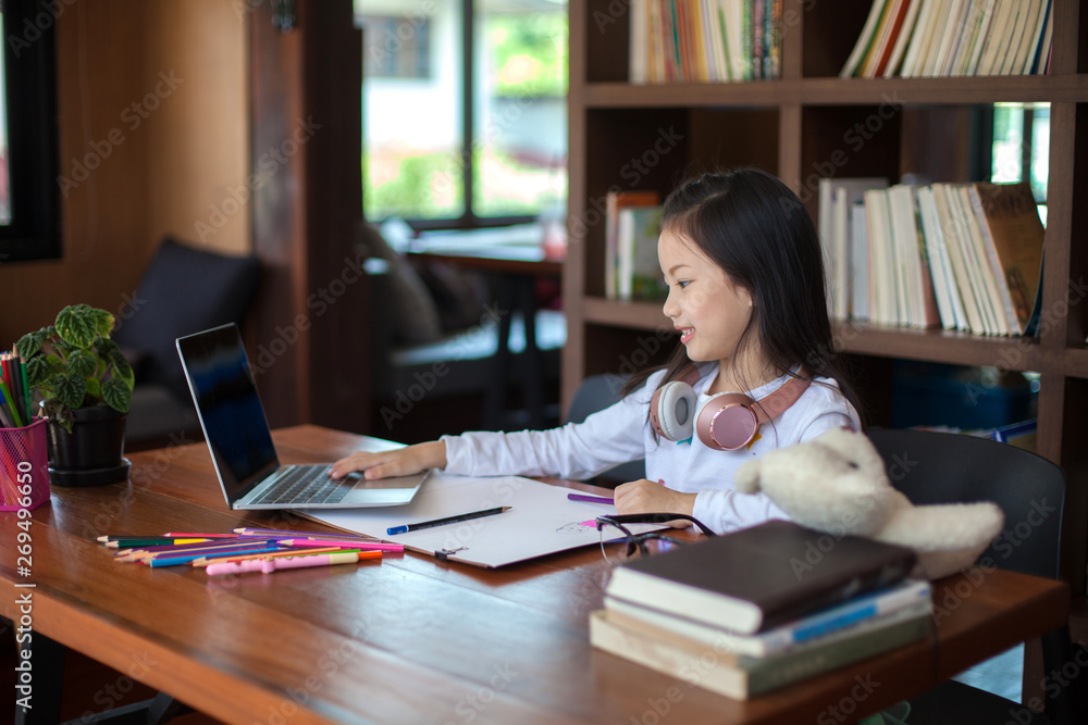 Asia little student girl studying and reading book at school - education and school concept Asia little student girl studying and reading book at school - education and school concept