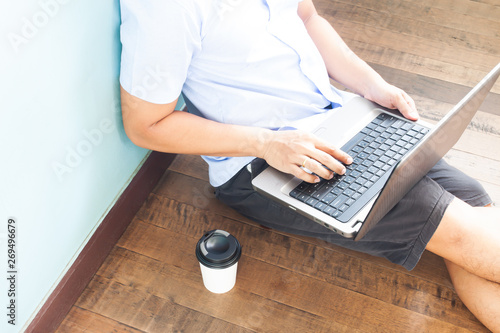 Man in casual style clothing using laptop computer. Technology and lifestyle concept