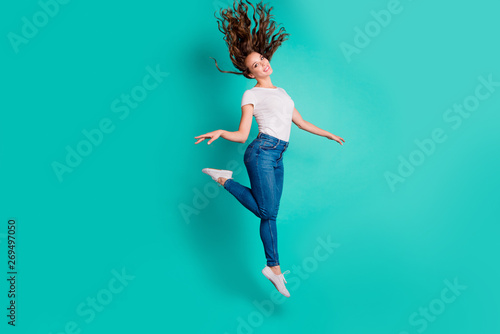 Full length body size view of her she nice-looking attractive lovely winsome sweet slim fit thin cheerful wavy-haired lady strolling having fun pleasure isolated on bright vivid shine blue background
