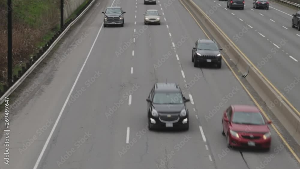 Cars on a highway moving under an overpass. Cars on a highway moving under an overpass.