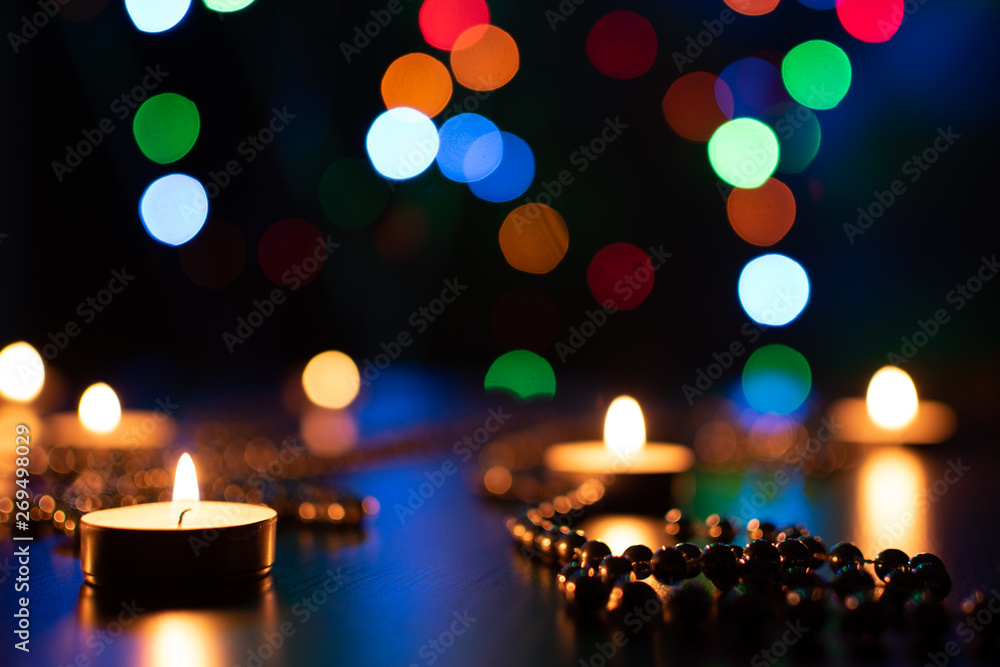 Fire of candle on christmas background. Christmas candles burning at night. Abstract candles background. Golden light of candle flame. Hope, fire. Candle lights in the darkness. Fire of candle on christmas background. Christmas candles burning at night. Abstract candles background. Golden light of candle flame. Hope, fire. Candle lights in the darkness.