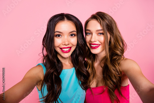 Close up photo two beautiful she her ladies graduation coquettish show perfect prom look web camera instagram followers wear shiny colorful dresses formal-wear isolated pink rose vivid background