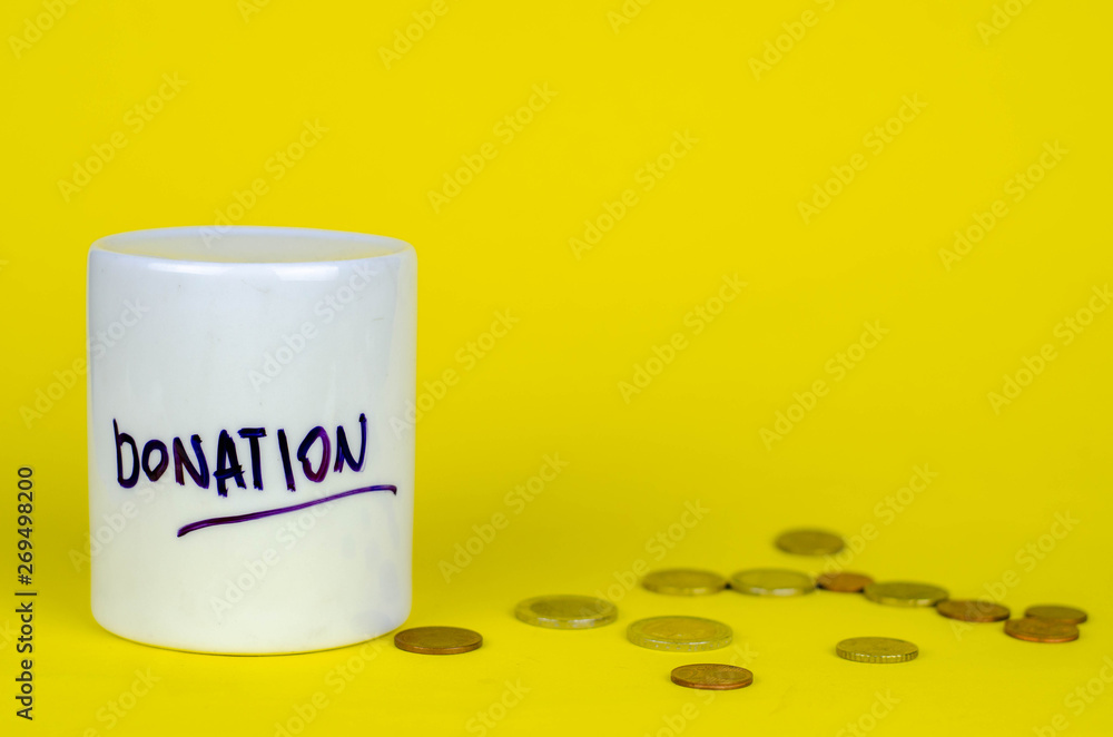money box with coins and banknotes on a yellow background. moneybox donate concept money box with coins and banknotes on a yellow background. moneybox donate concept