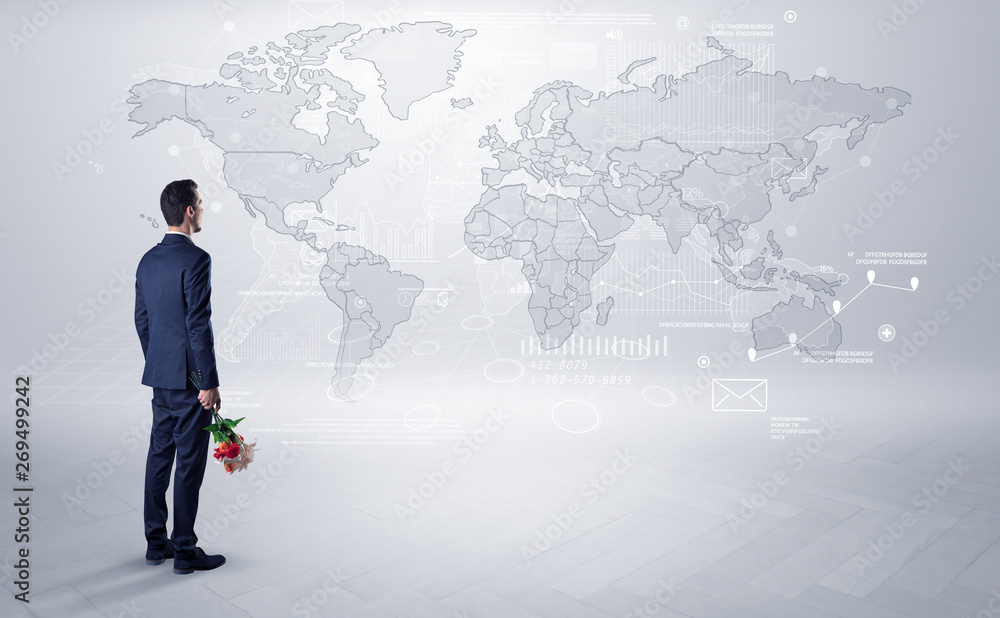 Businessman standing with his back and looking at a worldwide map with objects in his hand
Businessman standing with his back and looking at a worldwide map with objects in his hand