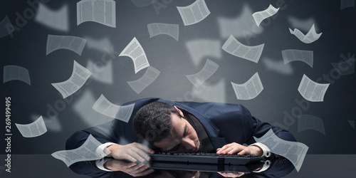 Young businessman fell asleep at the table with paperwork concept 