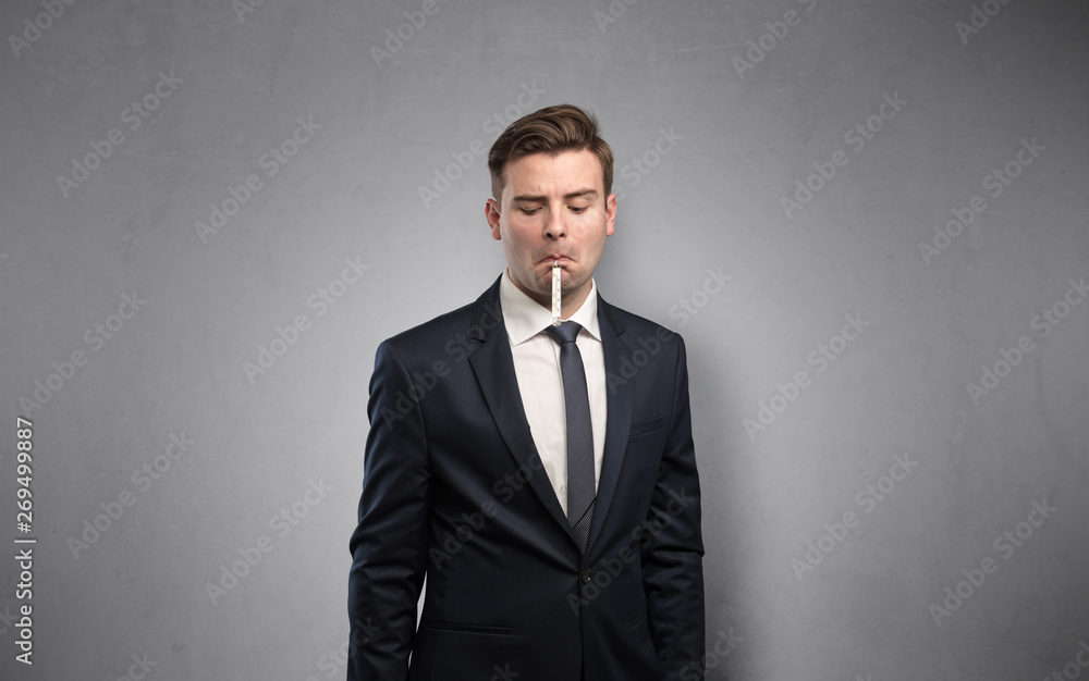 Young tired businessman with thermometer and copy space
Young tired businessman with thermometer and copy space