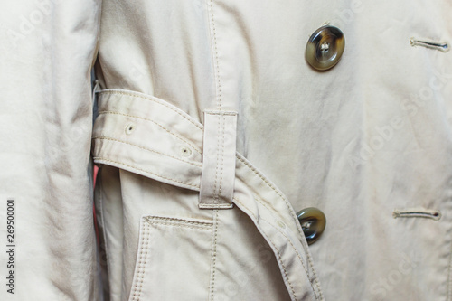 Woman trench in beige. Closeup details