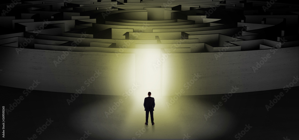 Businessman getting ready to enter a concentric labyrinth with lighted entrance concept
Businessman getting ready to enter a concentric labyrinth with lighted entrance concept
