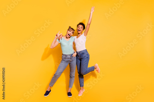 Full length body size photo beautiful she her lady laugh metal concert buddies fellows different nationalities hands arms raised wear casual white striped t-shirt isolated yellow bright background