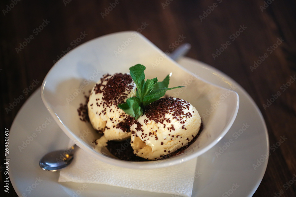 Ice cream balls in a white bowl in a cafe, dark Ice cream balls in a white bowl in a cafe, dark