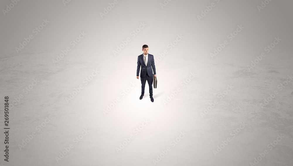 Young businessman standing alone in the middle of an empty space

