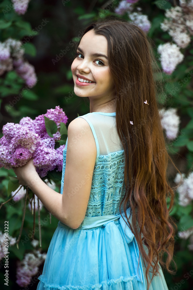 .Beautiful girl in lilac Garden. Girl with lilac flowers in springtime. Gardening. .Beautiful girl in lilac Garden. Girl with lilac flowers in springtime. Gardening.