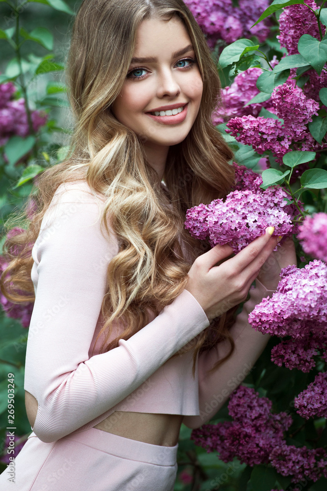 Beautiful girl in lilac Garden. Girl with lilac flowers in springtime. Gardening. Beautiful girl in lilac Garden. Girl with lilac flowers in springtime. Gardening.