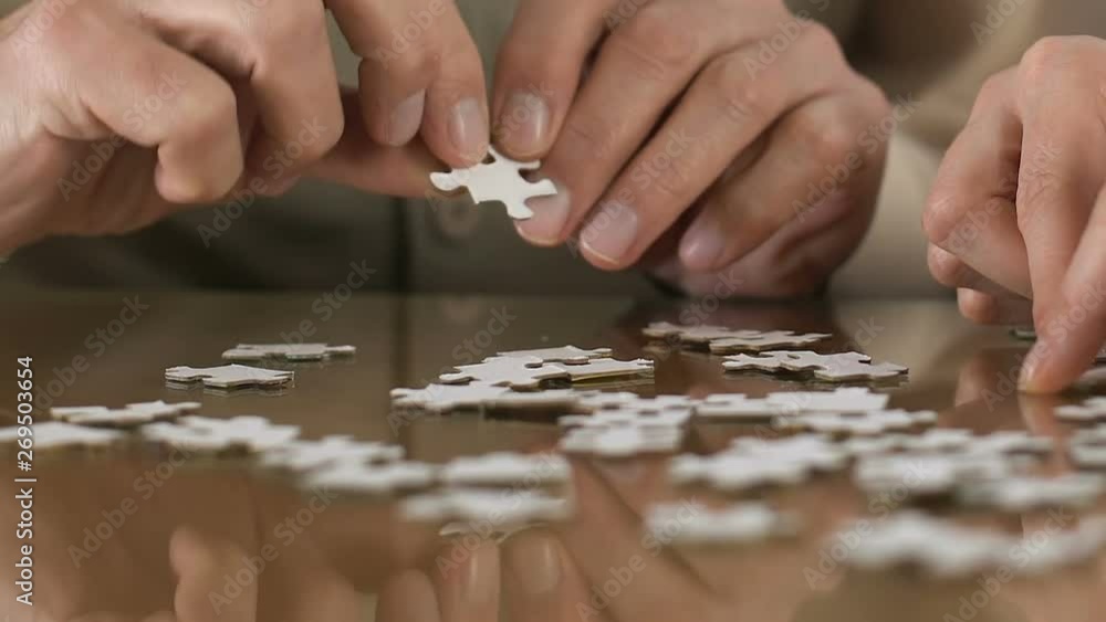 Nurse helping old man combing puzzle, development of senior people skills Nurse helping old man combing puzzle, development of senior people skills