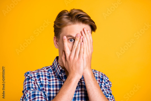 Close up photo amazing he him his man arms fingers hiding eyes full fear oh no facial expression epic fail lost scary movie wear casual plaid checkered shirt outfit isolated yellow bright background