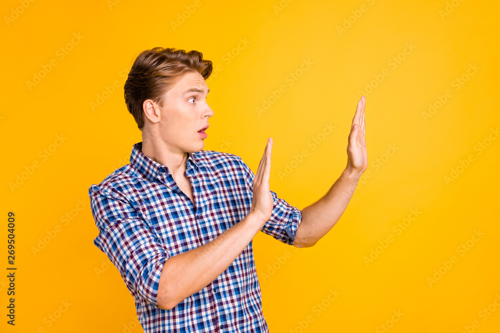 Close up side profile photo amazed he him his man mouth open eyes full fear oh no facial expression hands arms raised empty space ask stop wear plaid checkered shirt isolated yellow bright background Close up side profile photo amazed he him his man mouth open eyes full fear oh no facial expression hands arms raised empty space ask stop wear plaid checkered shirt isolated yellow bright background