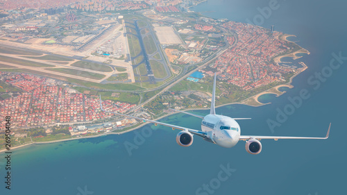 A passenger airplane is flying over istanbul city with blue sea