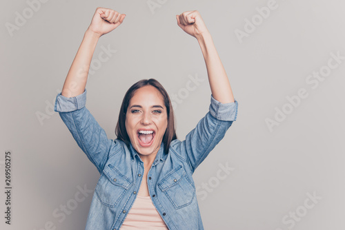 Close-up portrait of her she nice attractive cheerful cheery optimistic straight-haired lady showing winning power gesture raising hands up isolated over light white gray background