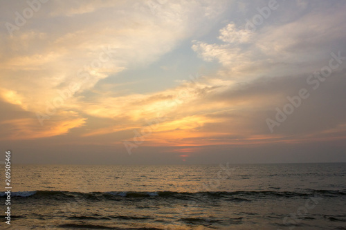 sea waves against a blue and orange sunset sky © Pavel