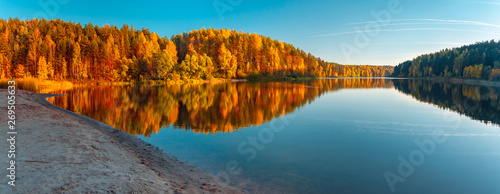 Silence at the forest lake at sunset, with reflection of sky and forest on a water smooth surface, a panorama from several frames, Russia, Mari El