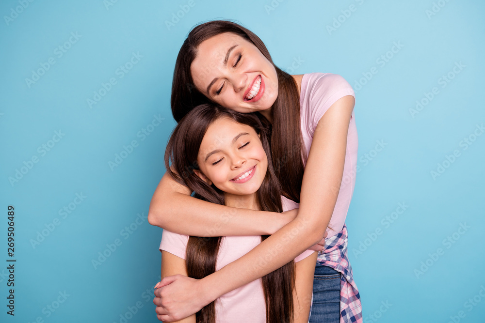 Close-up portrait of two nice-looking cute charming winsome attractive lovely sweet gentle tender cheerful straight-haired girls cuddling isolated on bright vivid shine blue turquoise background Close-up portrait of two nice-looking cute charming winsome attractive lovely sweet gentle tender cheerful straight-haired girls cuddling isolated on bright vivid shine blue turquoise background