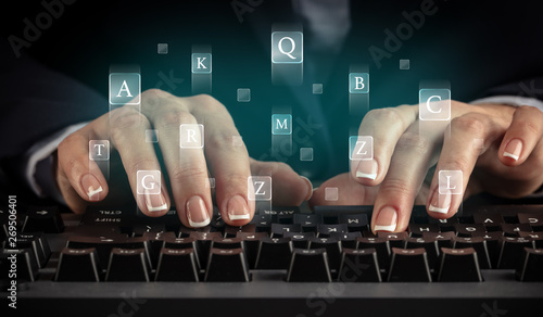 Business woman typing on keyboard with letters around 