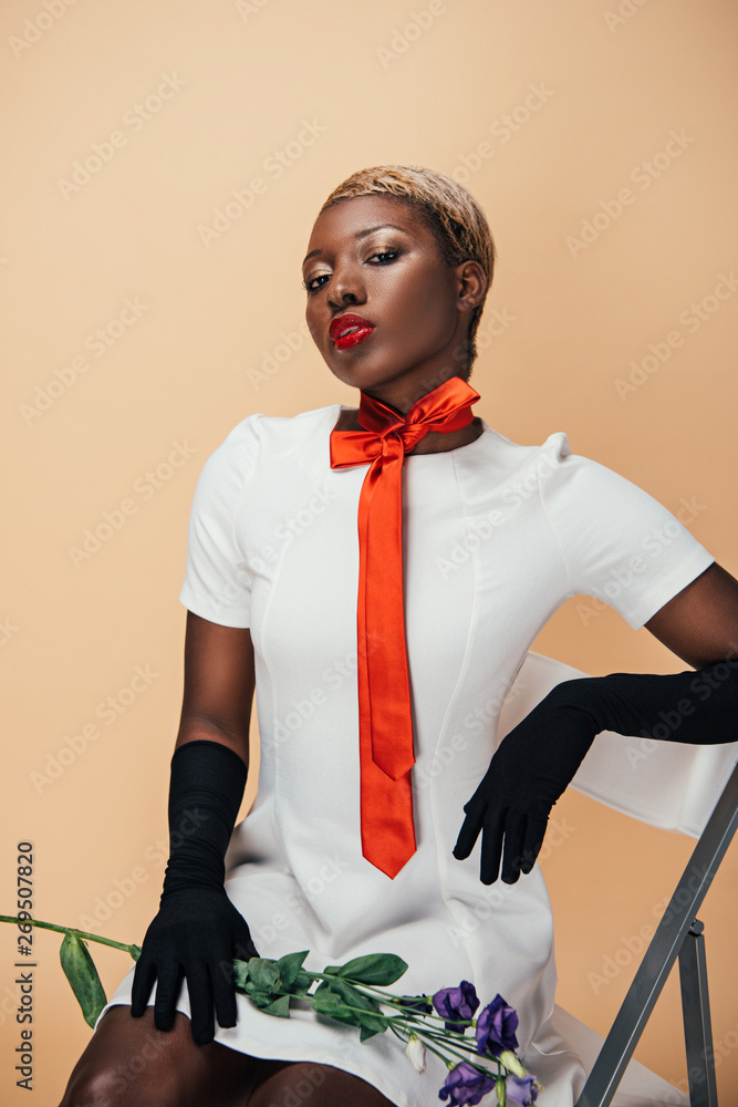 african american girl in white dress sitting on chair with eustoma ...