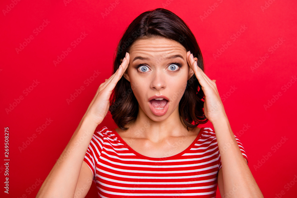 Close up photo of astonished frustrated lady teen teenager touch hands head forehead shout unbelievable unexpected horrible news information wear modern striped t-shirt isolated red background