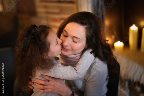 Mom and daughter communicate, hug and kiss in cafe