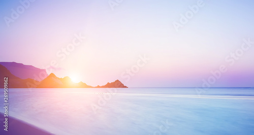 Sunset on a wild beach on the Indian Ocean. Golden sunset on the paradise island beach.