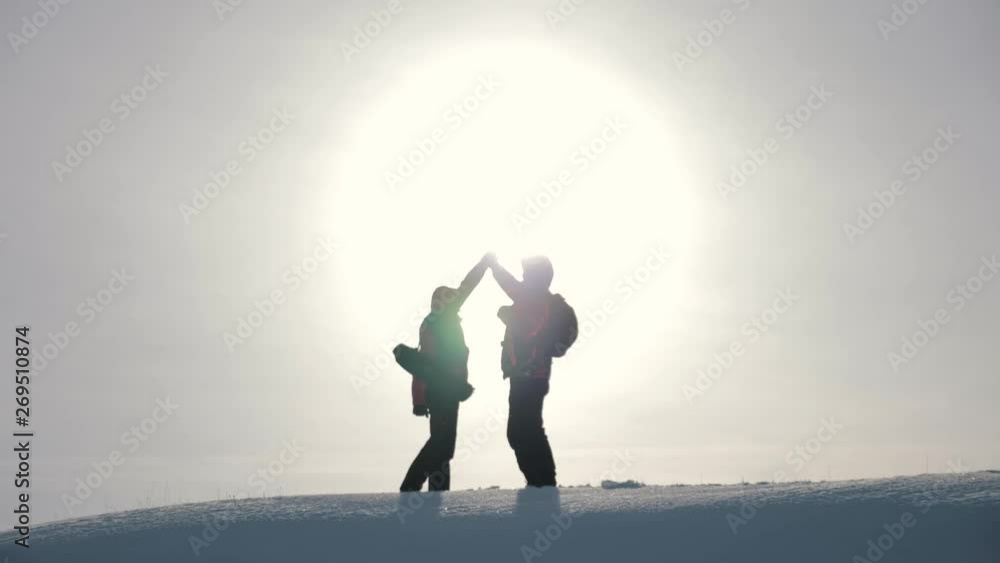 Tourists teamwork, climbing the mountain, helping each other, reaching the top. Overcoming difficulties, helping hand.