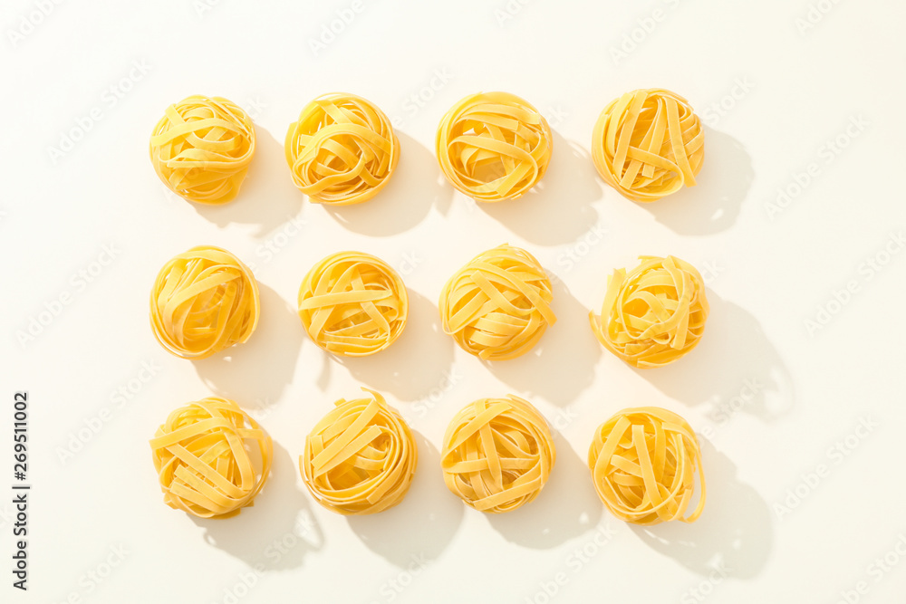 Flat lay composition with different pasta on white background, space for text Flat lay composition with different pasta on white background, space for text