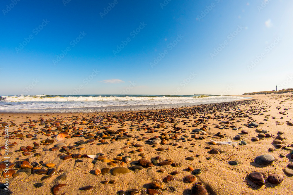 lonesome beach of the Baltic Sea with pebbles and blue sky lonesome beach of the Baltic Sea with pebbles and blue sky