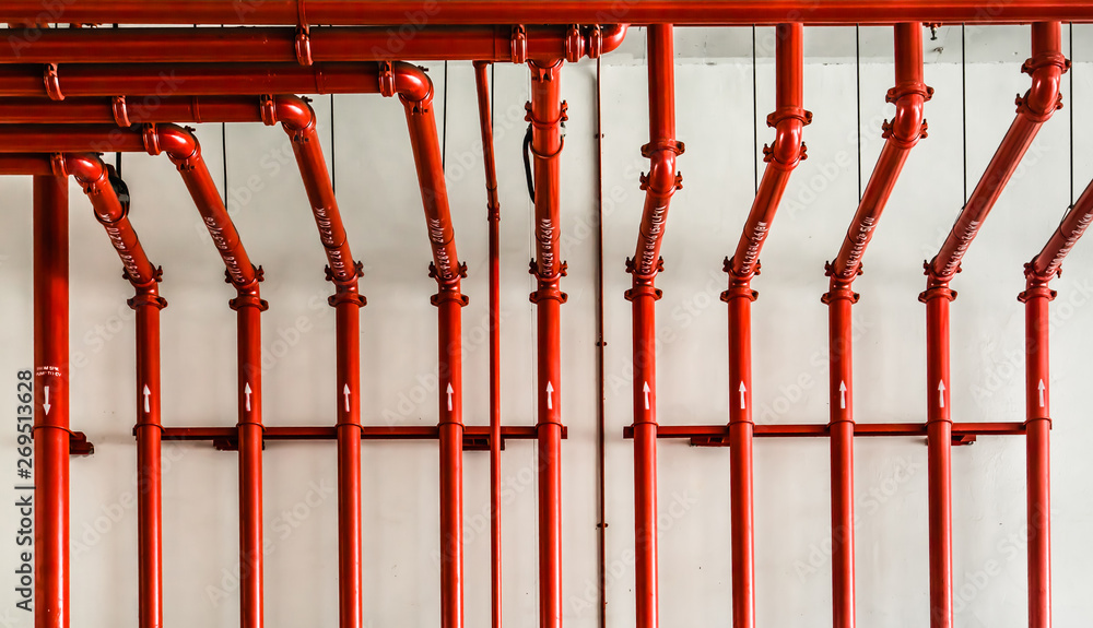 red color metal pipe on white wall - obrazy, fototapety, plakaty 