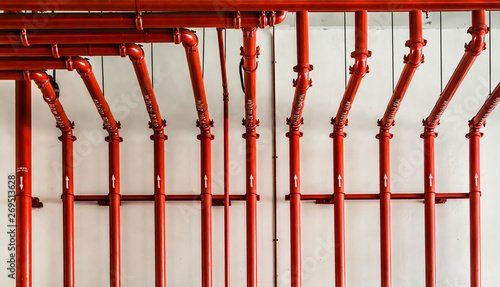 red color metal pipe on white wall